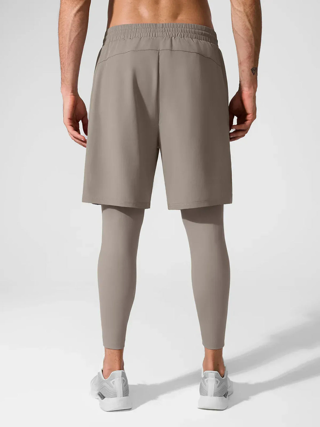 A model wearing a BRXL® 2-in-1 Training Pants for Men in