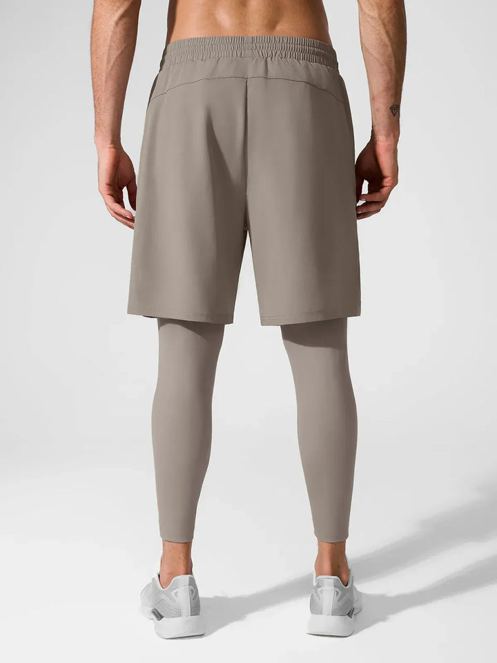 A model wearing a BRXL® 2-in-1 Training Pants for Men in