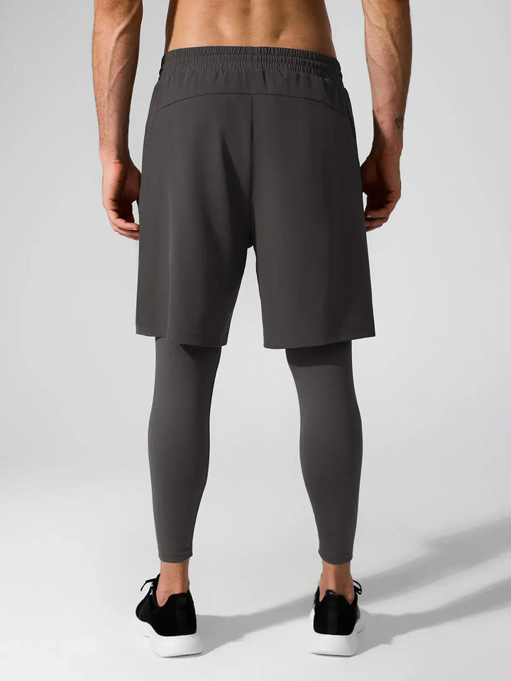 A model wearing a BRXL® 2-in-1 Training Pants for Men in