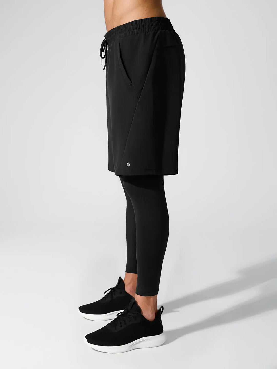 A model wearing a BRXL® 2-in-1 Training Pants for Men in