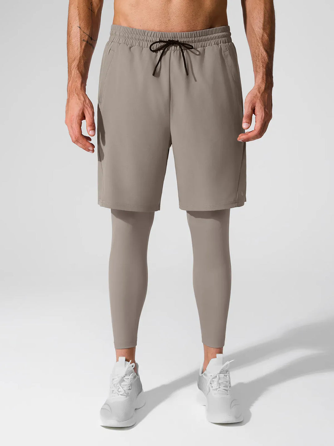 A model wearing a BRXL® 2-in-1 Training Pants for Men in Charcoal / S