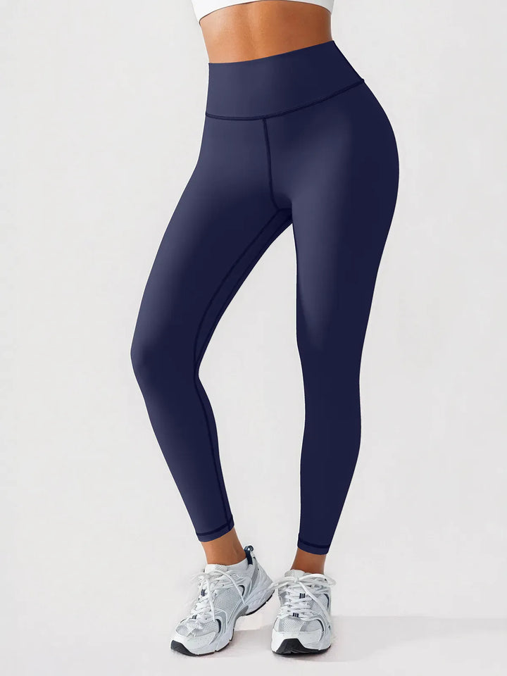 A model wearing a BRXL® BrxlGrit™ Scrunch High Rise Gym Leggings in Dark Blue / XS