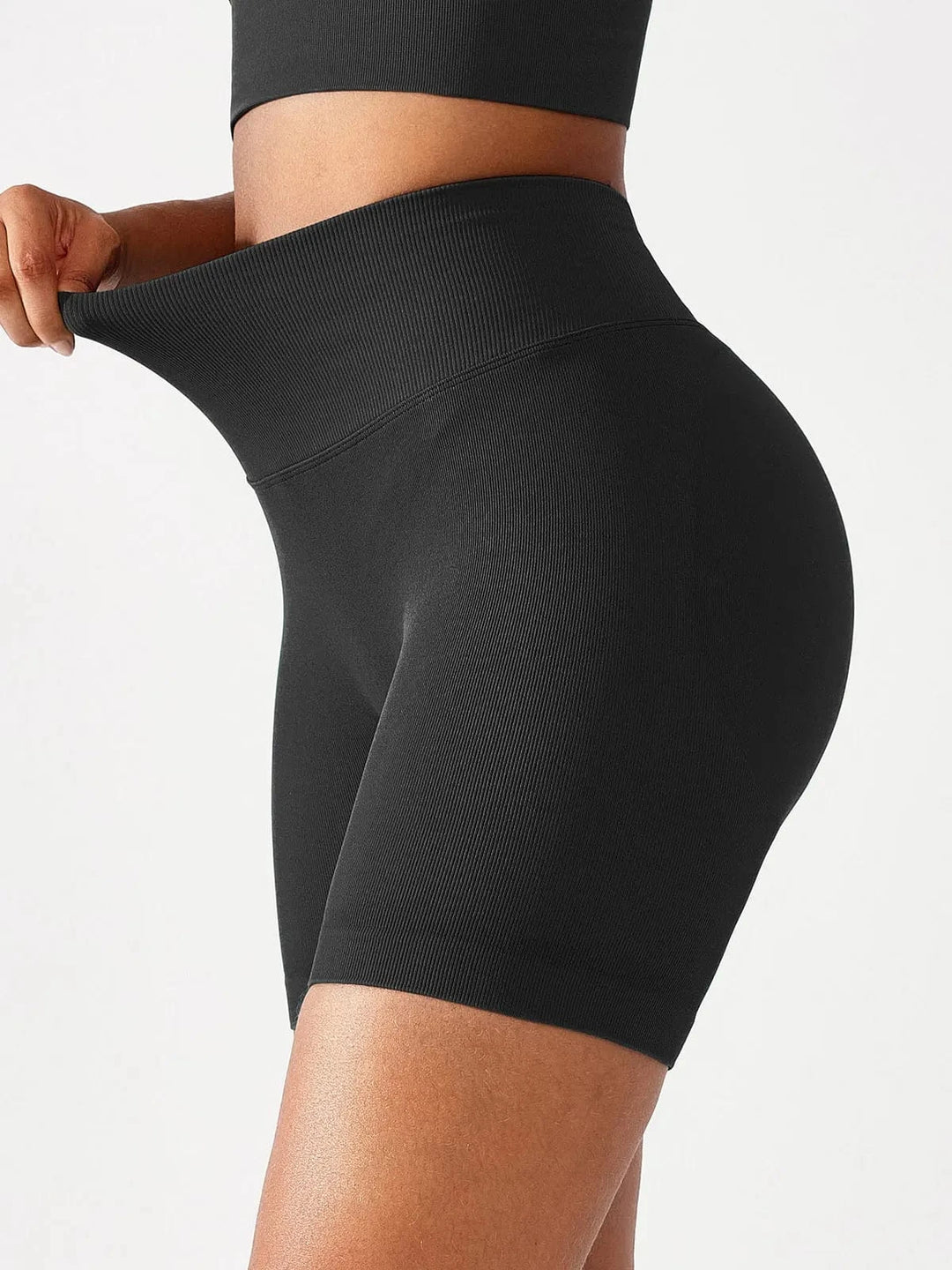 A model wearing a BRXL® BrxlGrit™ Seamless Scrunch Butt Workout Shorts in