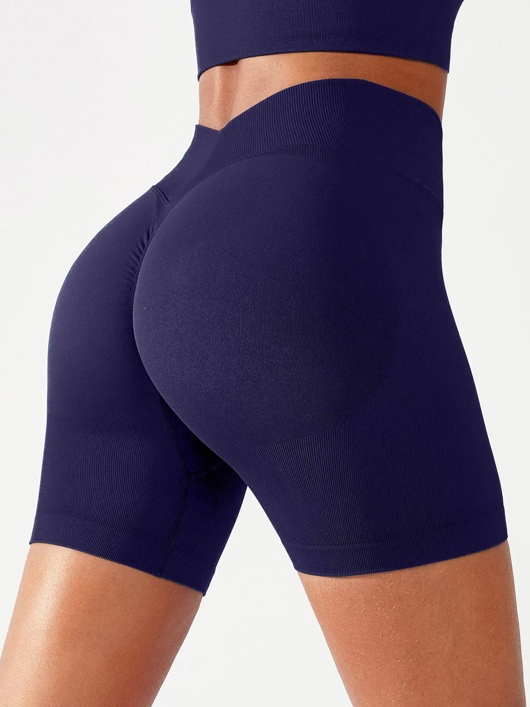 A model wearing a BRXL® BrxlGrit™ Seamless Scrunch Butt Workout Shorts in