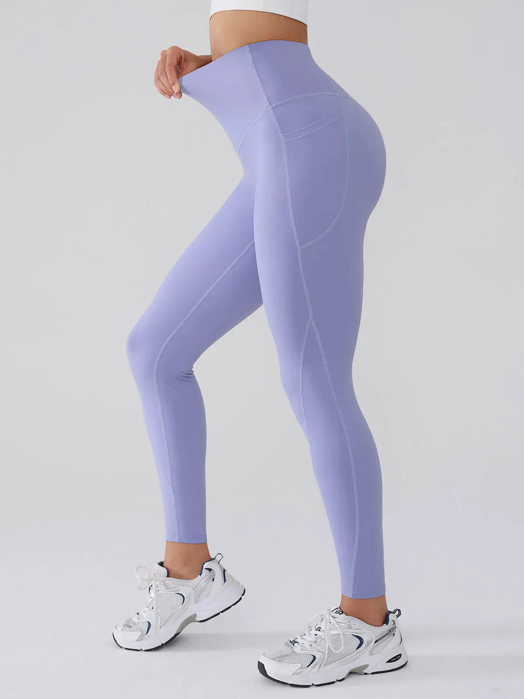 A model wearing a BRXL® BrxlGrit™ Tummy Control High Waisted Leggings in Blue / XS