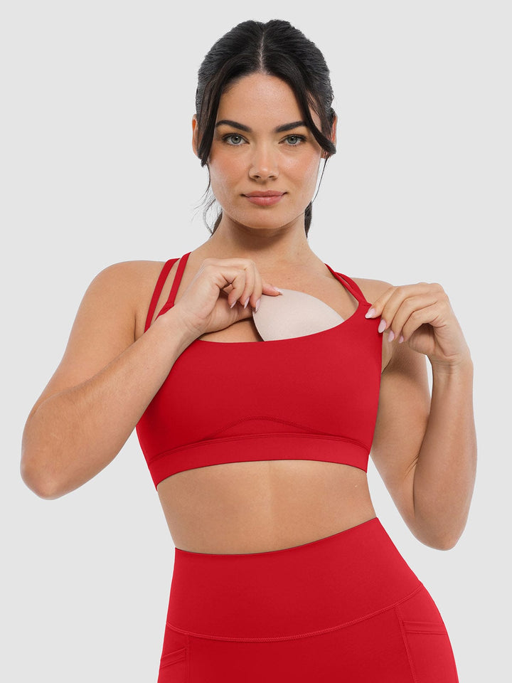 A model wearing a BRXL® BrxlZero™ Cross Back Strappy Sports Bra in