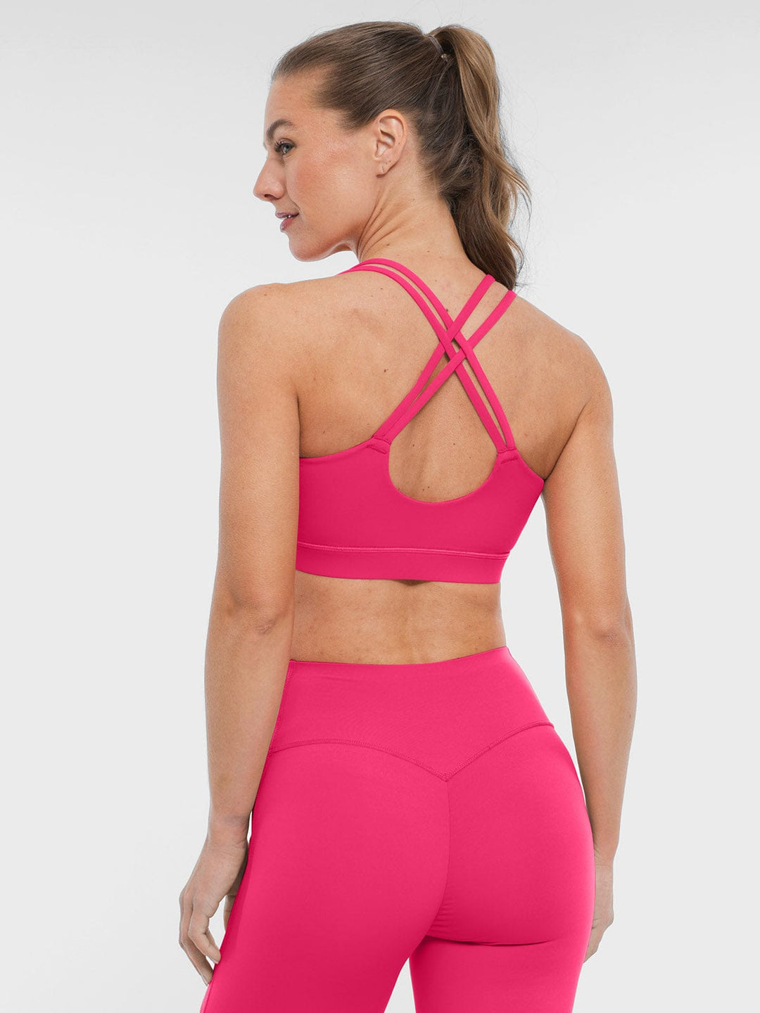 A model wearing a BRXL® BrxlZero™ Cross Back Strappy Sports Bra in