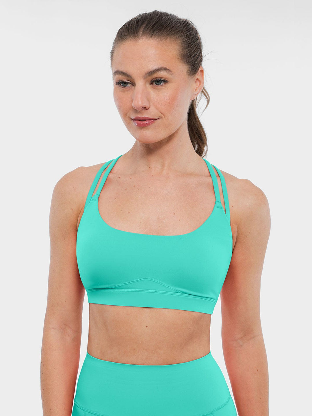 A model wearing a BRXL® BrxlZero™ Cross Back Strappy Sports Bra in