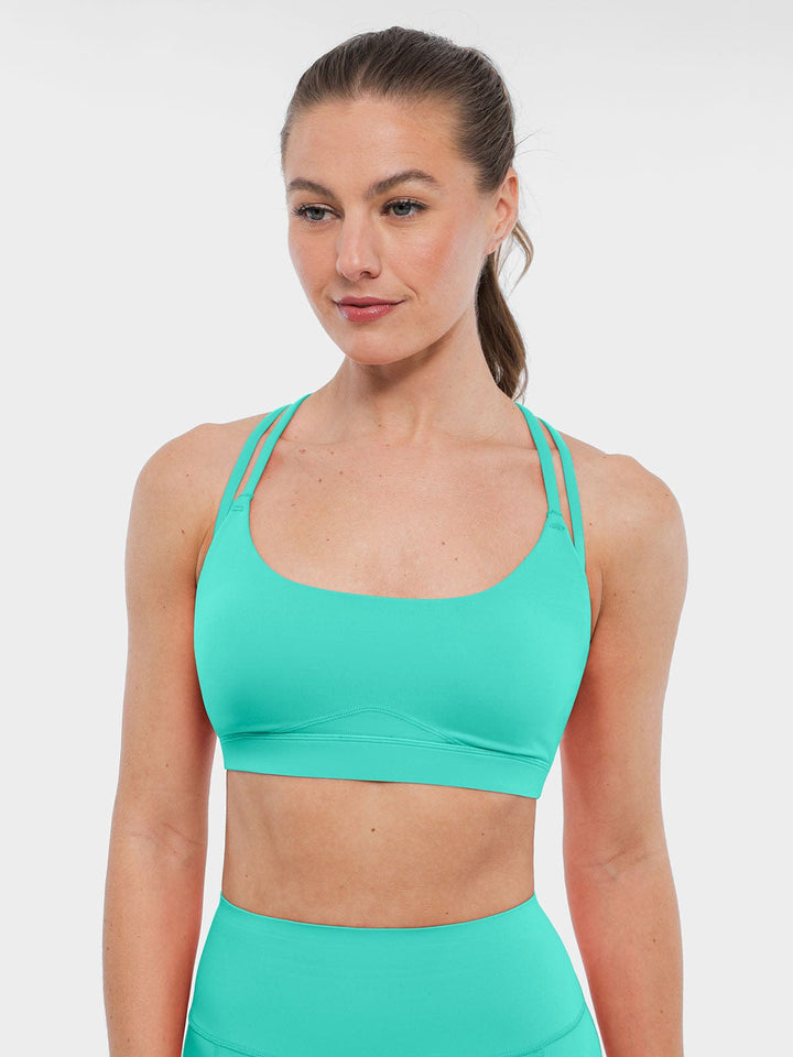 A model wearing a BRXL® BrxlZero™ Cross Back Strappy Sports Bra in