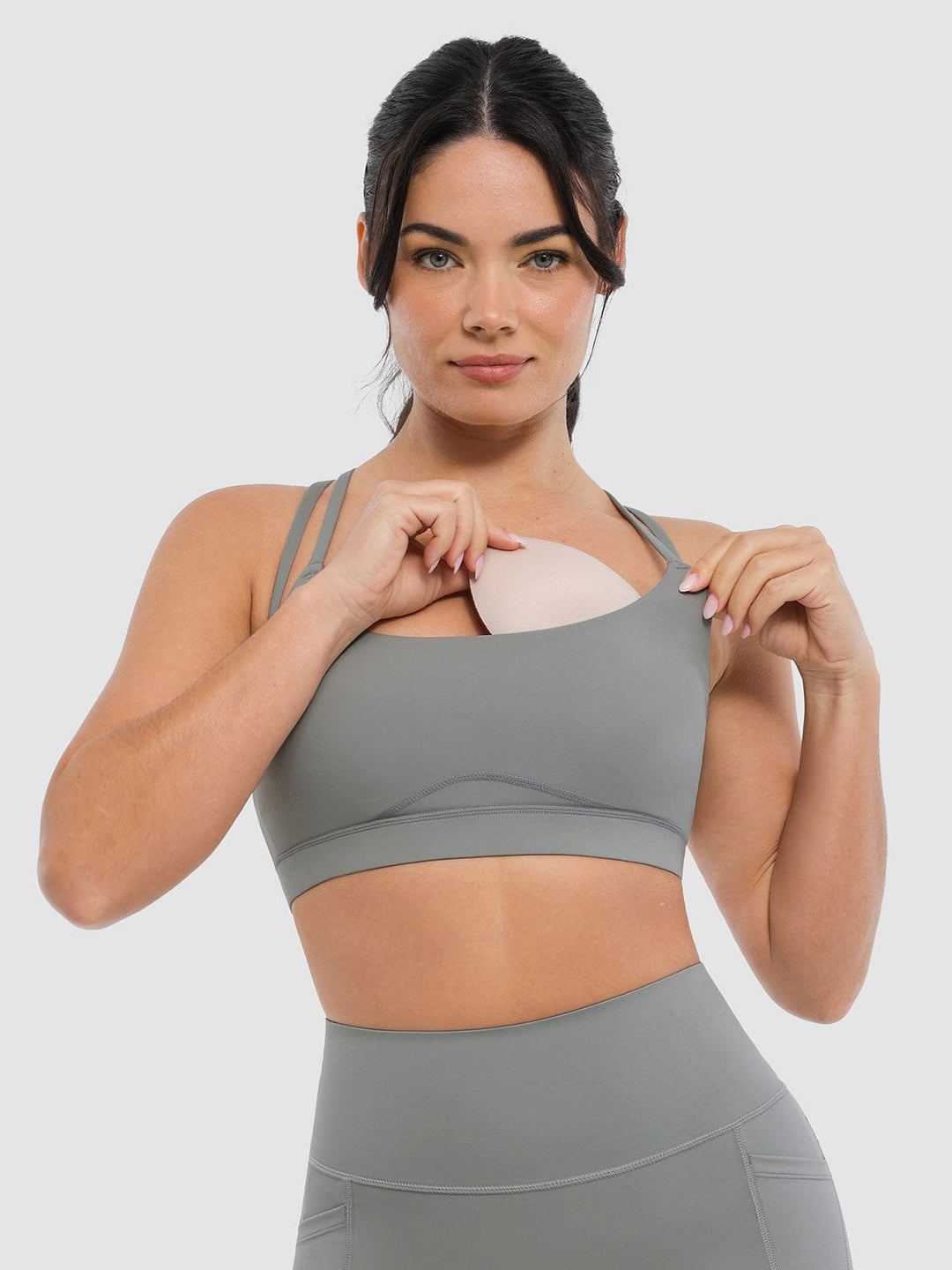 A model wearing a BRXL® BrxlZero™ Cross Back Strappy Sports Bra in