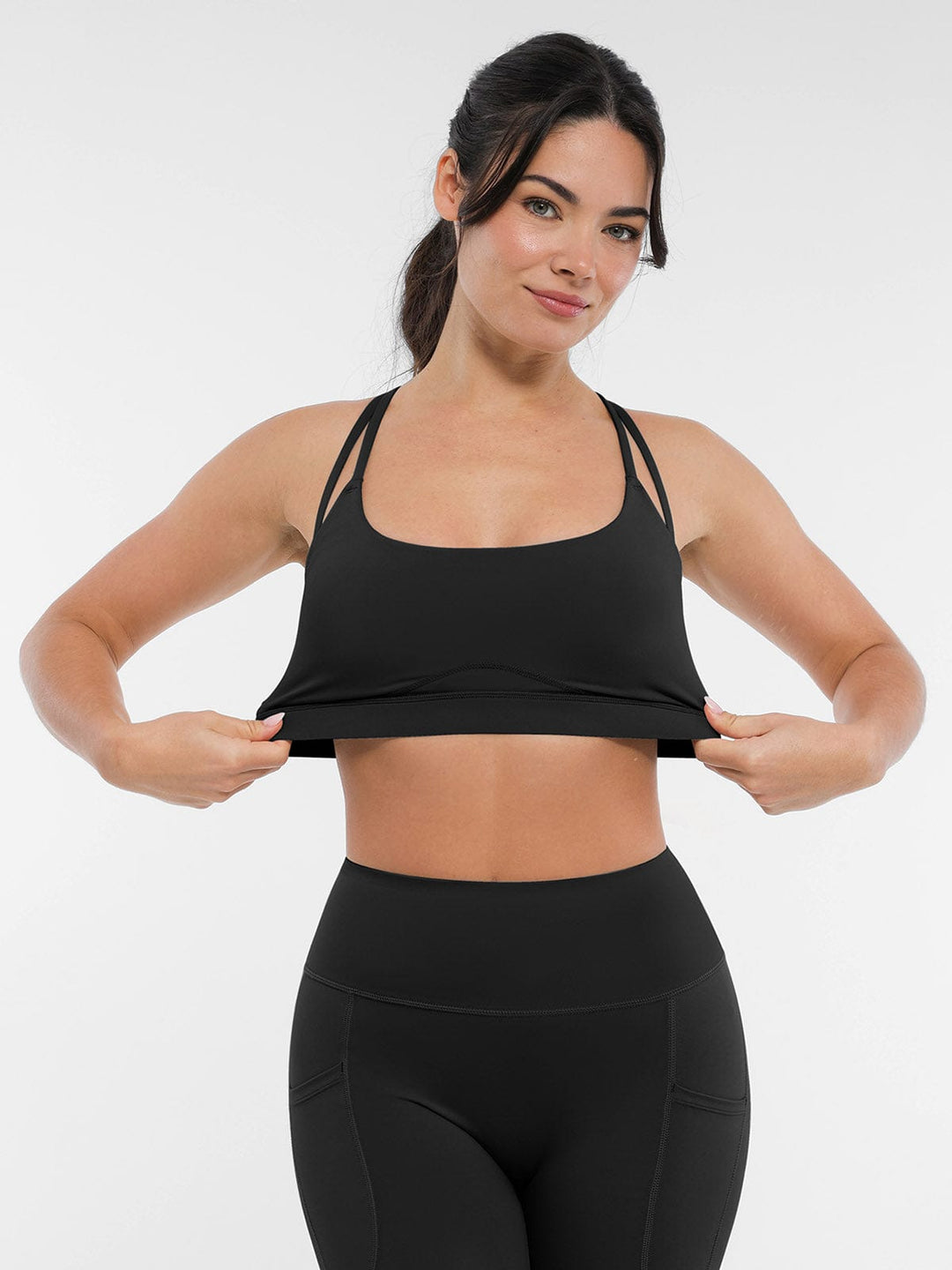 A model wearing a BRXL® BrxlZero™ Cross Back Strappy Sports Bra in