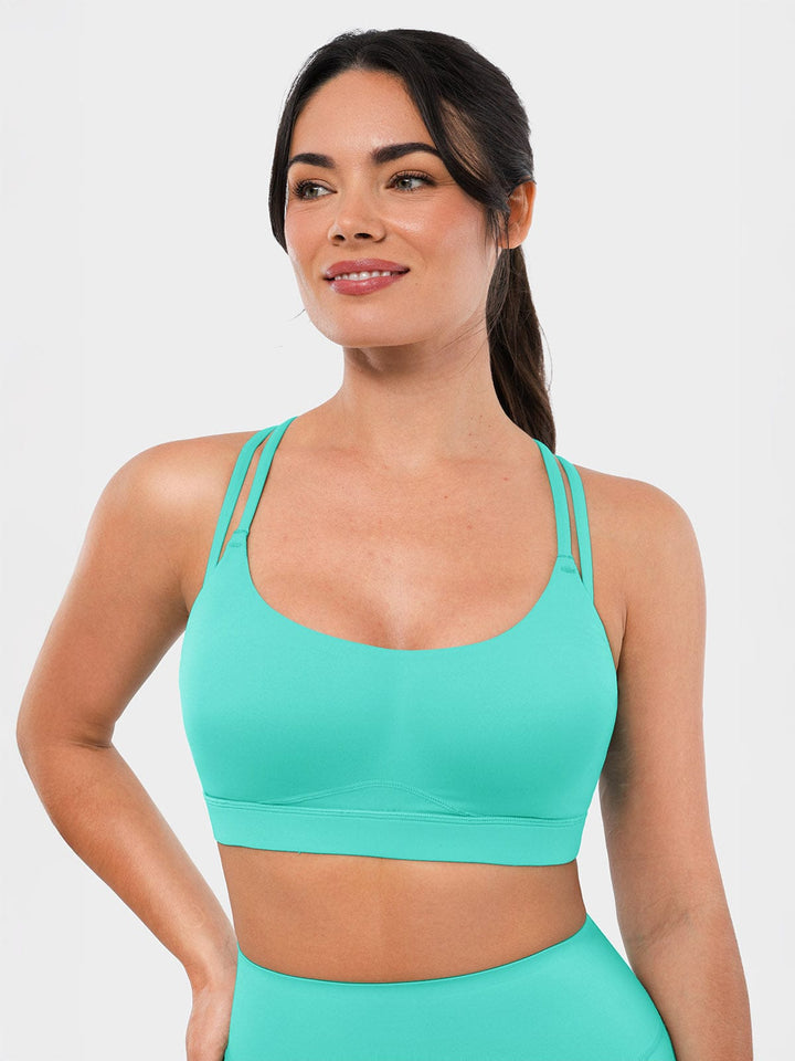 A model wearing a BRXL® BrxlZero™ Cross Back Strappy Sports Bra in Mint Green / XS