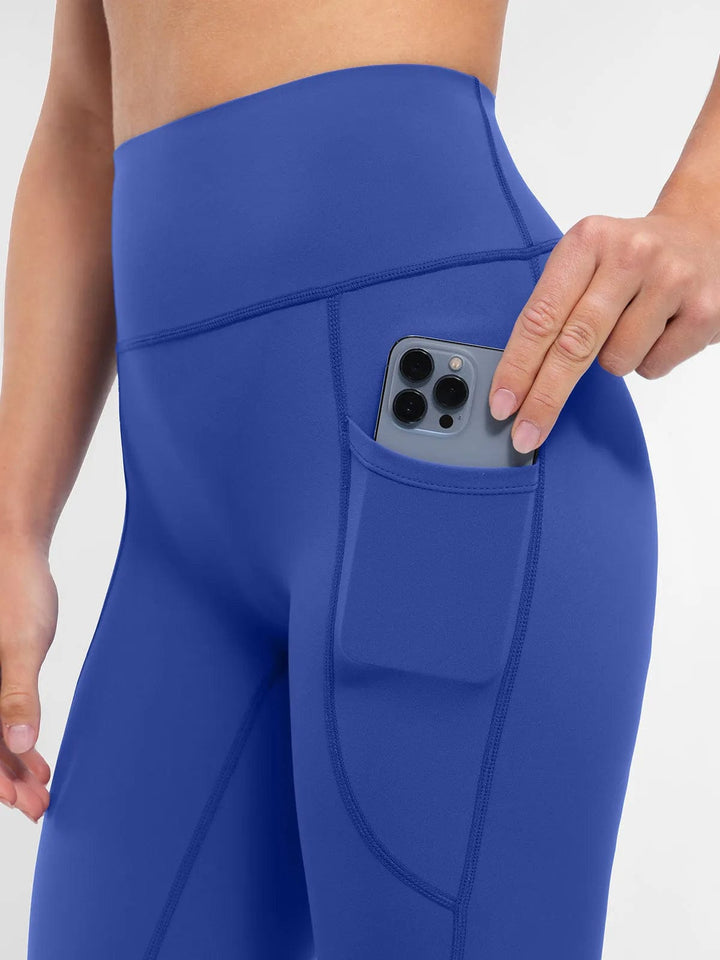 A model wearing a BRXL® BrxlZero™ High Rise Buttery Soft Yoga Leggings in