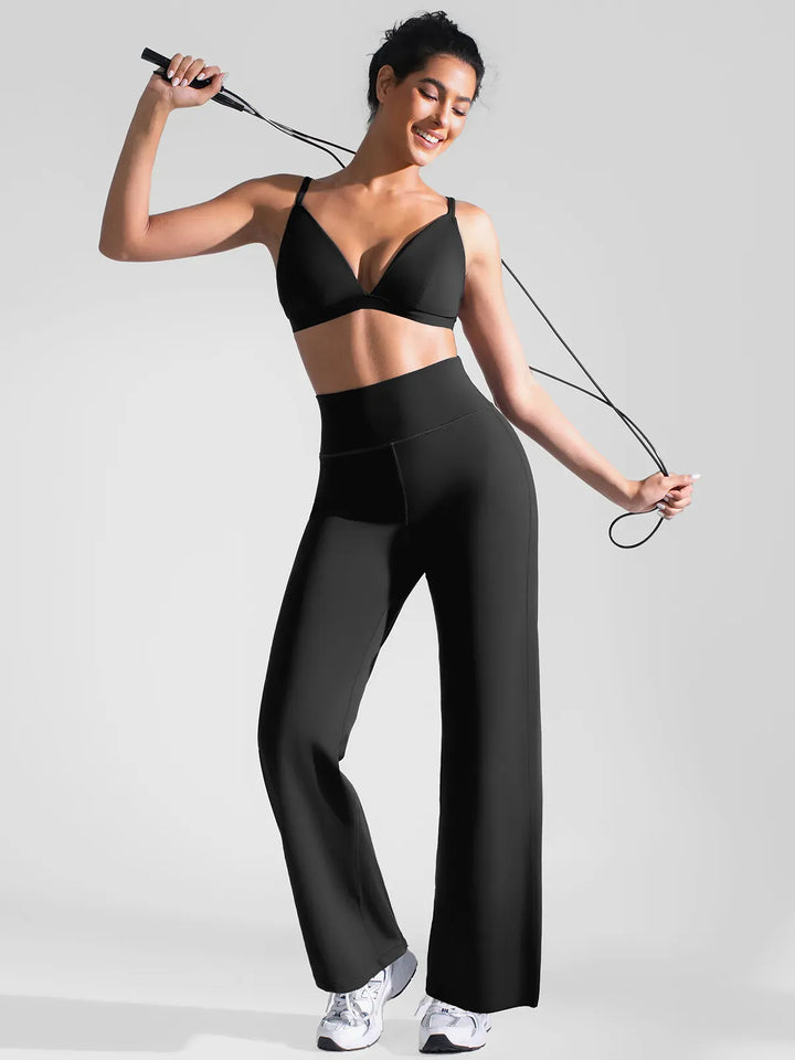 A model wearing a BRXL® Butt Lift Wide Leg Workout Pants in