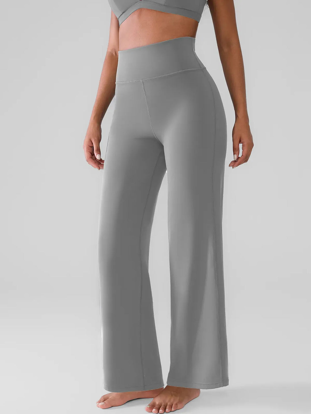 A model wearing a BRXL® Butt Lift Wide Leg Workout Pants in