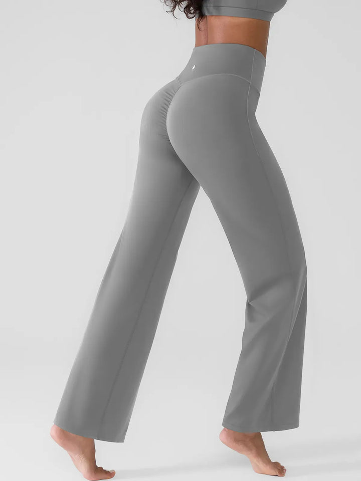 A model wearing a BRXL® Butt Lift Wide Leg Workout Pants in Gray / XS