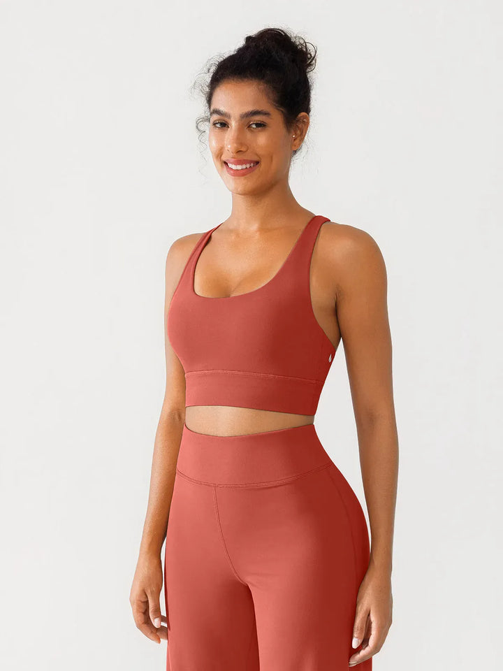 A model wearing a BRXL® Criss Cross Strappy Yoga Sports Bra in