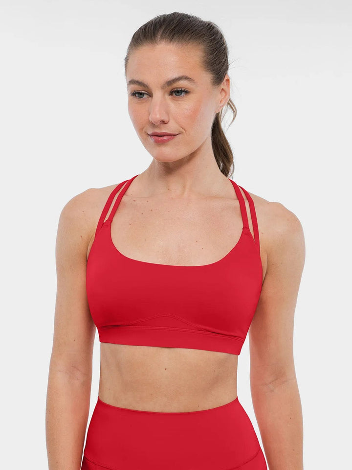 A model wearing a BRXL® Cross Strap Sports Bra High-Waisted Shorts Set in