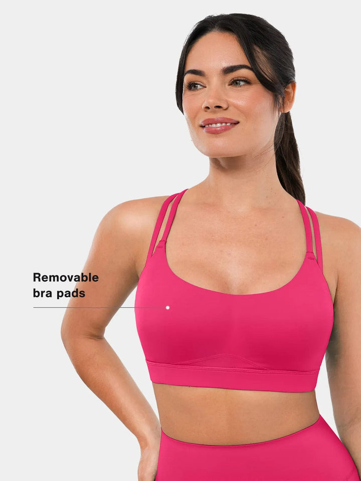 A model wearing a BRXL® Cross Strap Sports Bra High-Waisted Shorts Set in