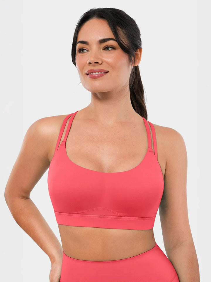 A model wearing a BRXL® Cross Strap Sports Bra High-Waisted Shorts Set in