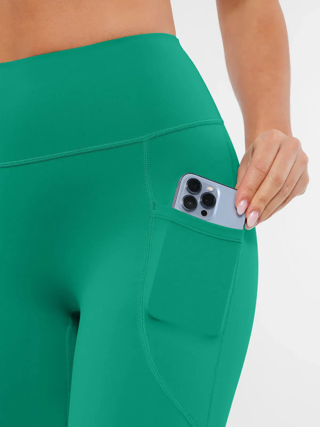 A model wearing a BRXL® Cross Strap Sports Bra Sculpted Leggings Set in