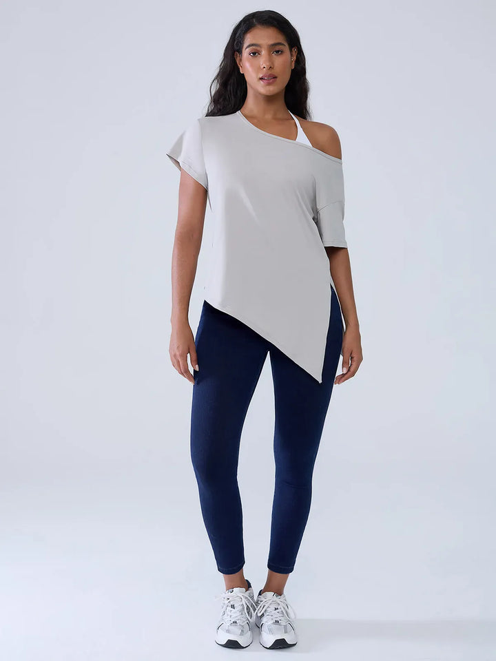 A model wearing a BRXL® Crossover Denim Sculpting Leggings with Pockets in