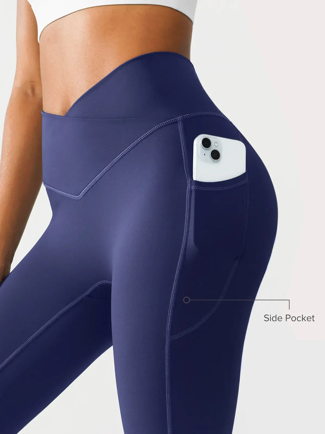 A model wearing a BRXL® Crossover Running Leggings with Pockets in