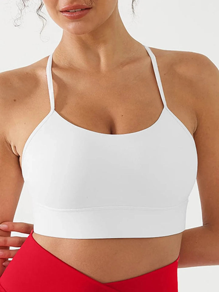 A model wearing a BRXL® Flow Y Racerback Bra with Low Cut and Spaghetti Straps in