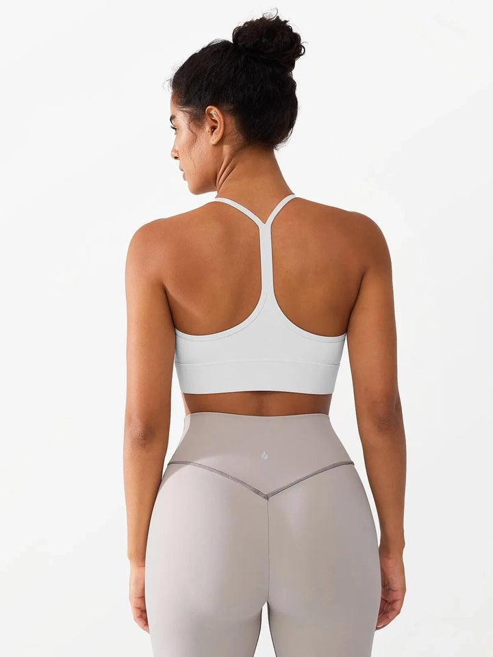 A model wearing a BRXL® Flow Y Racerback Bra with Low Cut and Spaghetti Straps in