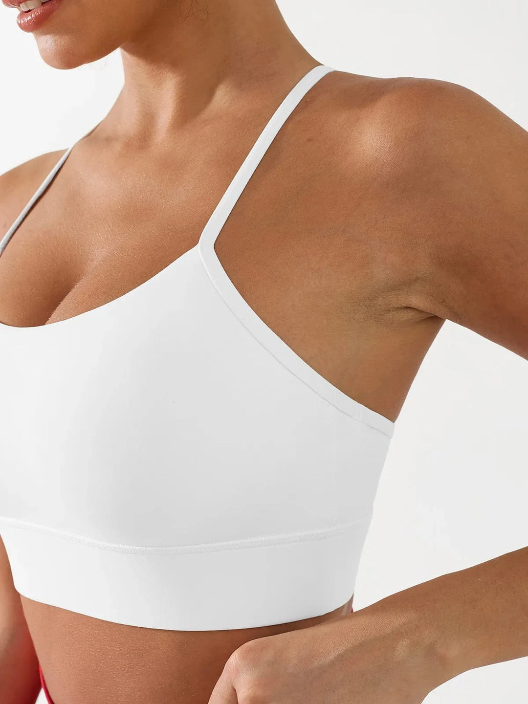 A model wearing a BRXL® Flow Y Racerback Bra with Low Cut and Spaghetti Straps in