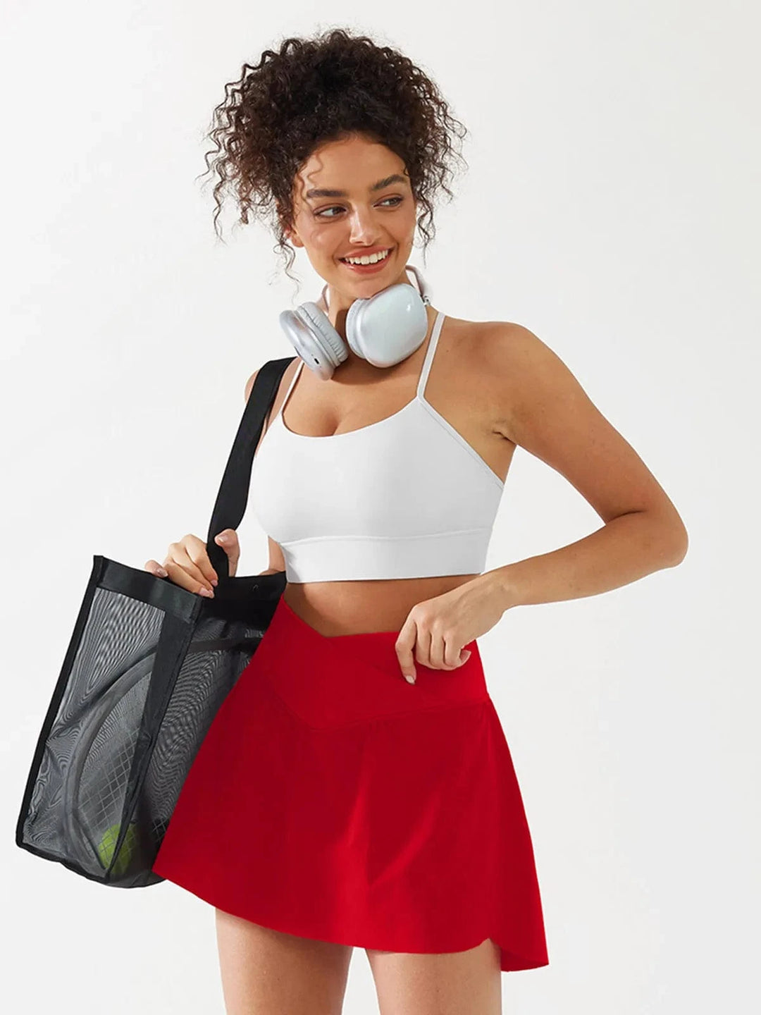 A model wearing a BRXL® Flow Y Racerback Bra with Low Cut and Spaghetti Straps in