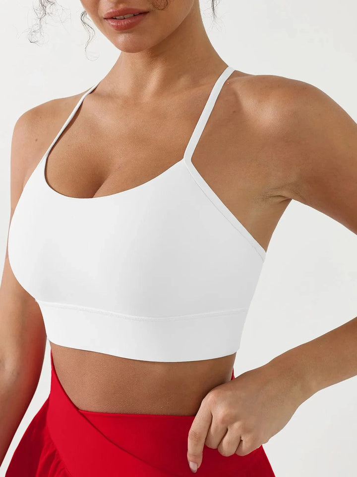 A model wearing a BRXL® Flow Y Racerback Bra with Low Cut and Spaghetti Straps in