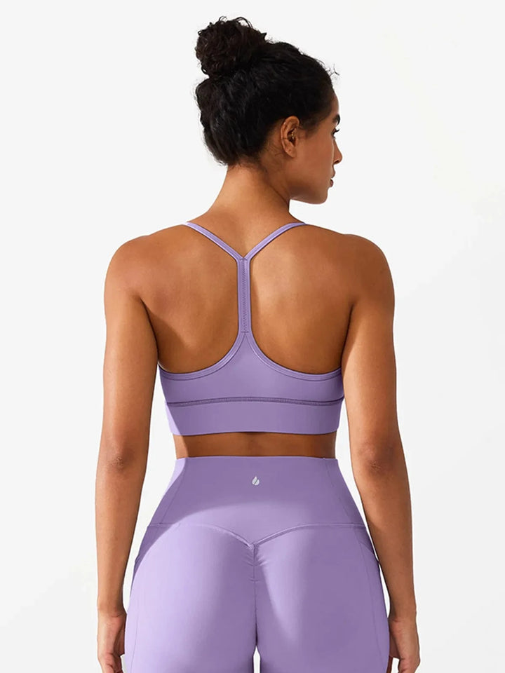 A model wearing a BRXL® Flow Y Racerback Bra with Low Cut and Spaghetti Straps in