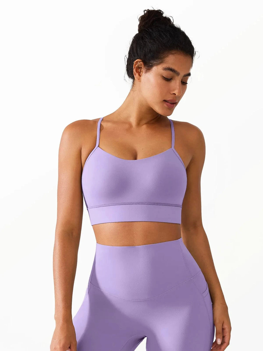 A model wearing a BRXL® Flow Y Racerback Bra with Low Cut and Spaghetti Straps in