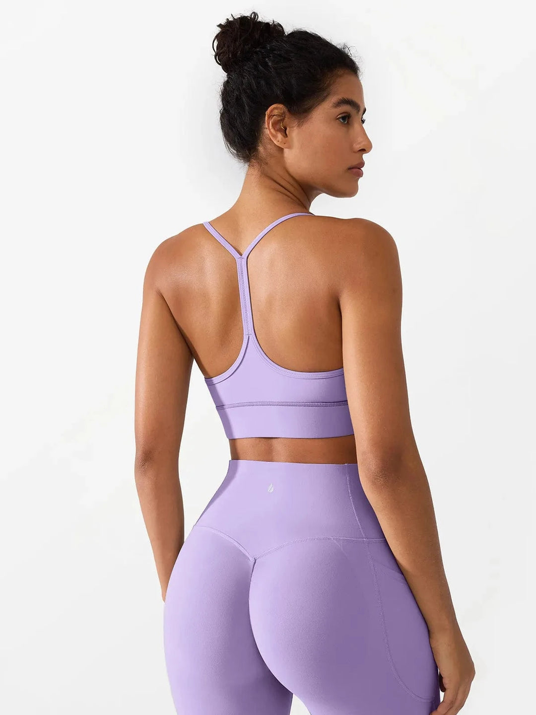 A model wearing a BRXL® Flow Y Racerback Bra with Low Cut and Spaghetti Straps in