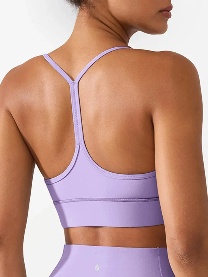 A model wearing a BRXL® Flow Y Racerback Bra with Low Cut and Spaghetti Straps in