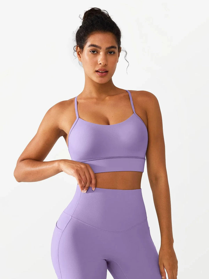 A model wearing a BRXL® Flow Y Racerback Bra with Low Cut and Spaghetti Straps in