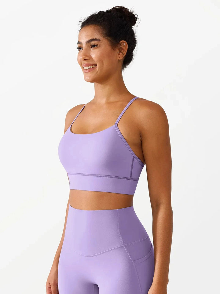 A model wearing a BRXL® Flow Y Racerback Bra with Low Cut and Spaghetti Straps in