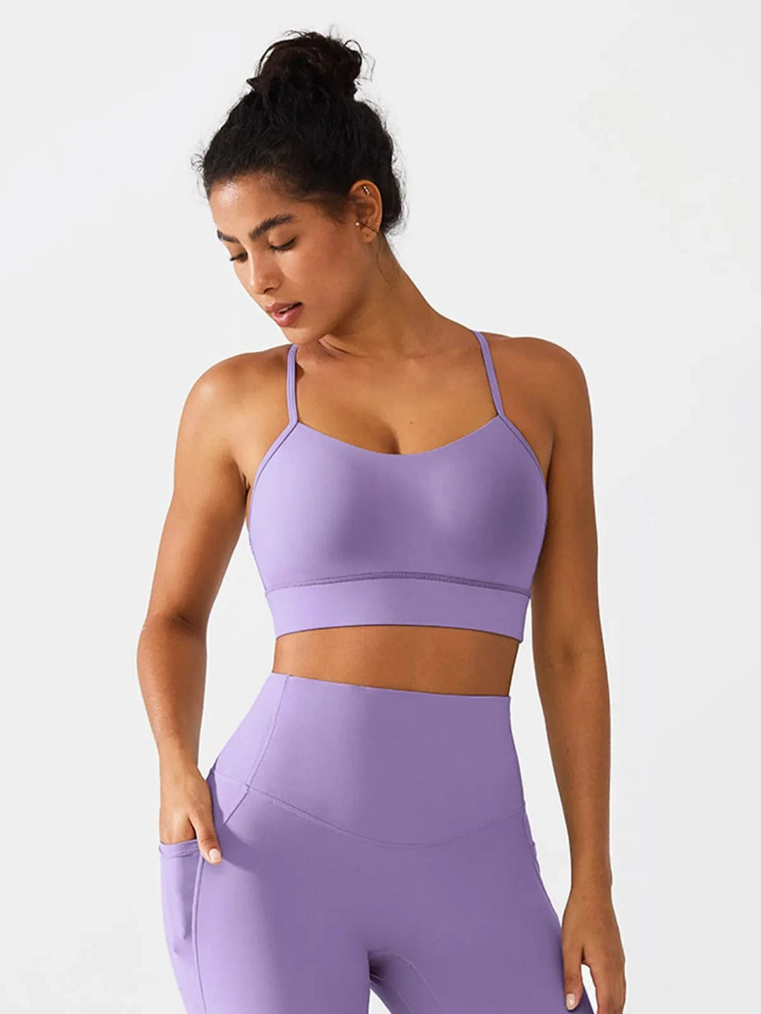 A model wearing a BRXL® Flow Y Racerback Bra with Low Cut and Spaghetti Straps in