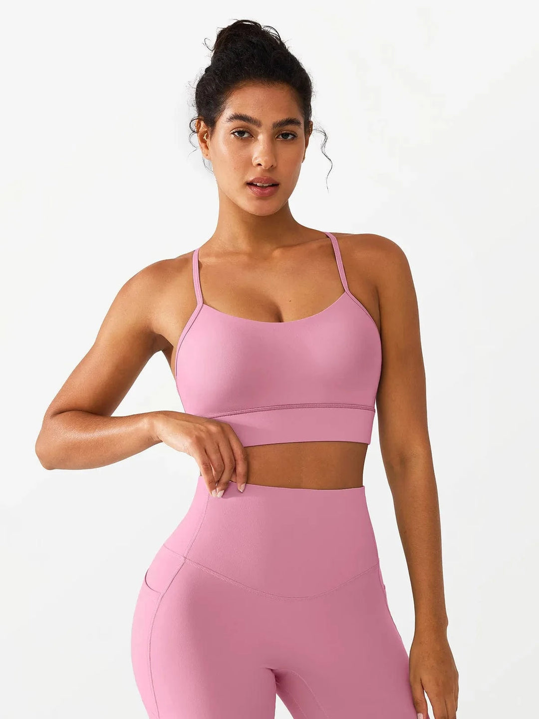 A model wearing a BRXL® Flow Y Racerback Bra with Low Cut and Spaghetti Straps in