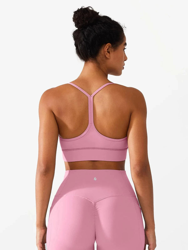 A model wearing a BRXL® Flow Y Racerback Bra with Low Cut and Spaghetti Straps in