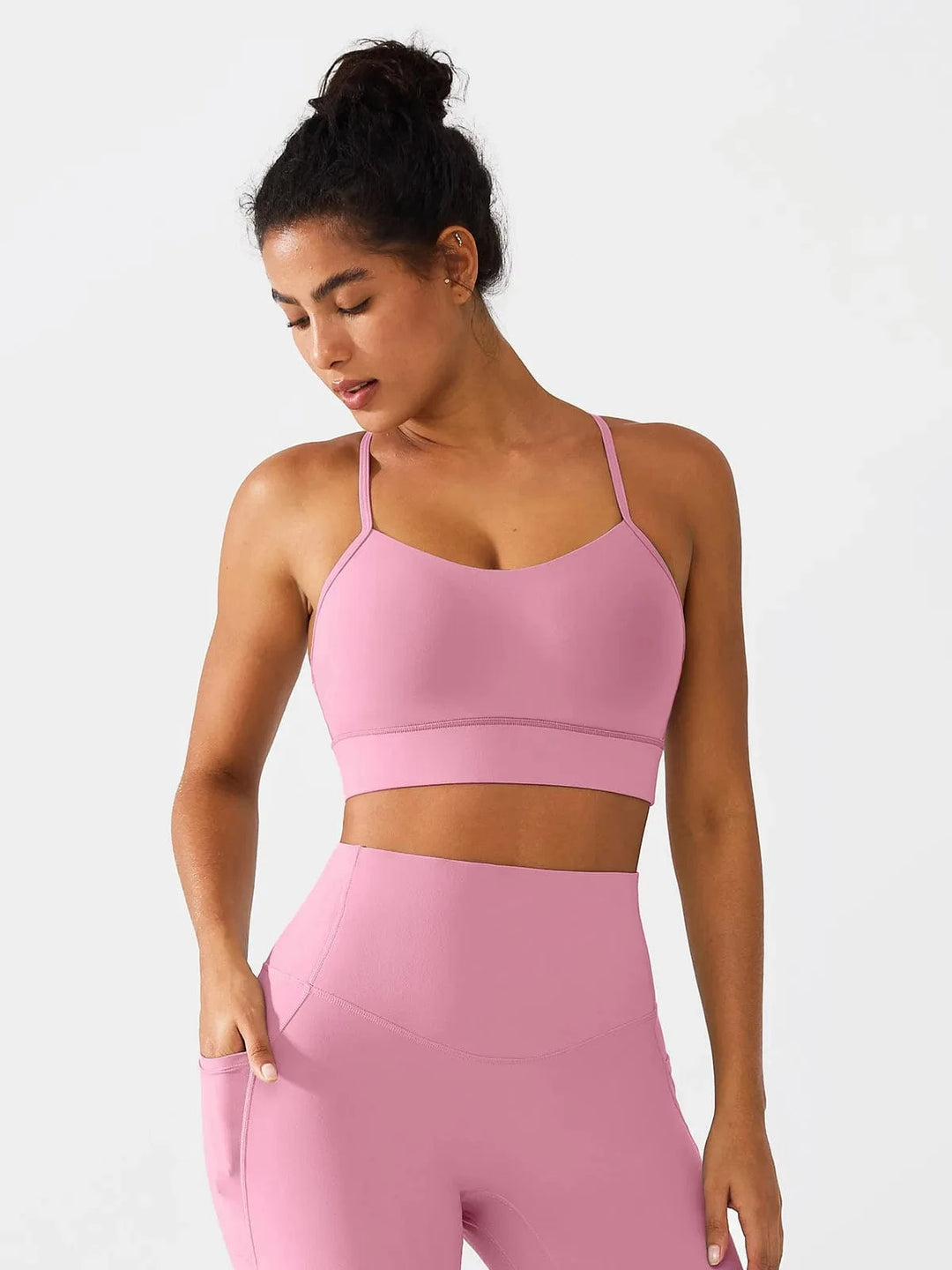 A model wearing a BRXL® Flow Y Racerback Bra with Low Cut and Spaghetti Straps in