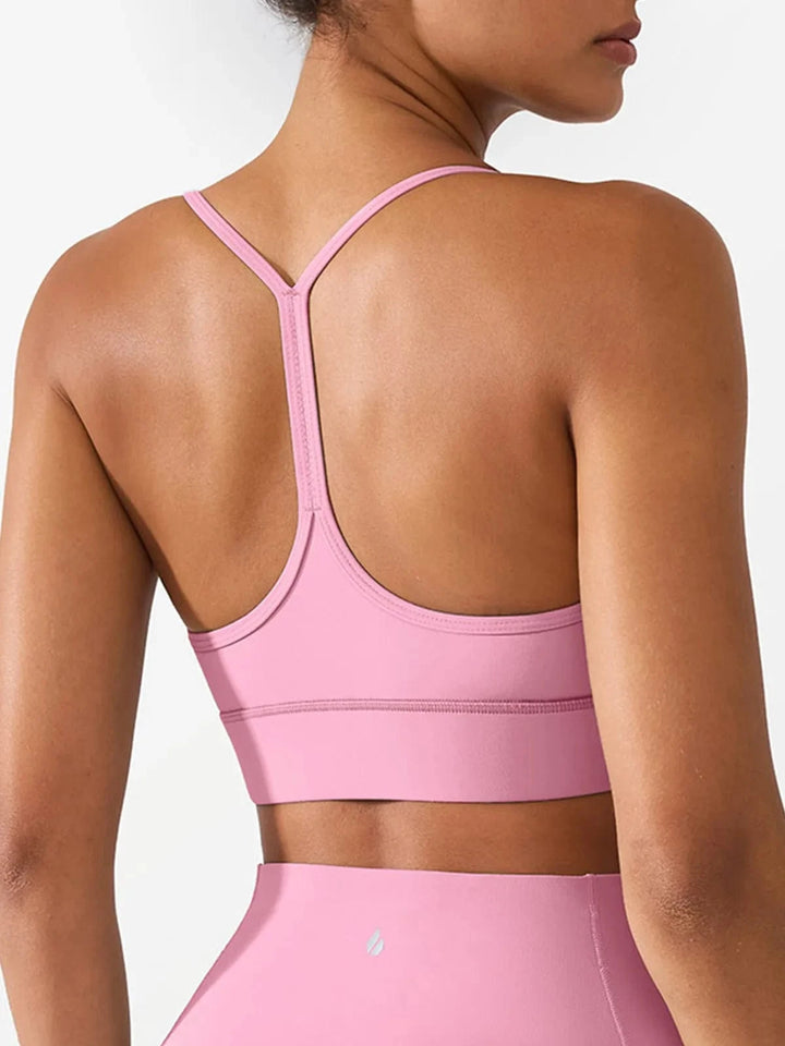 A model wearing a BRXL® Flow Y Racerback Bra with Low Cut and Spaghetti Straps in