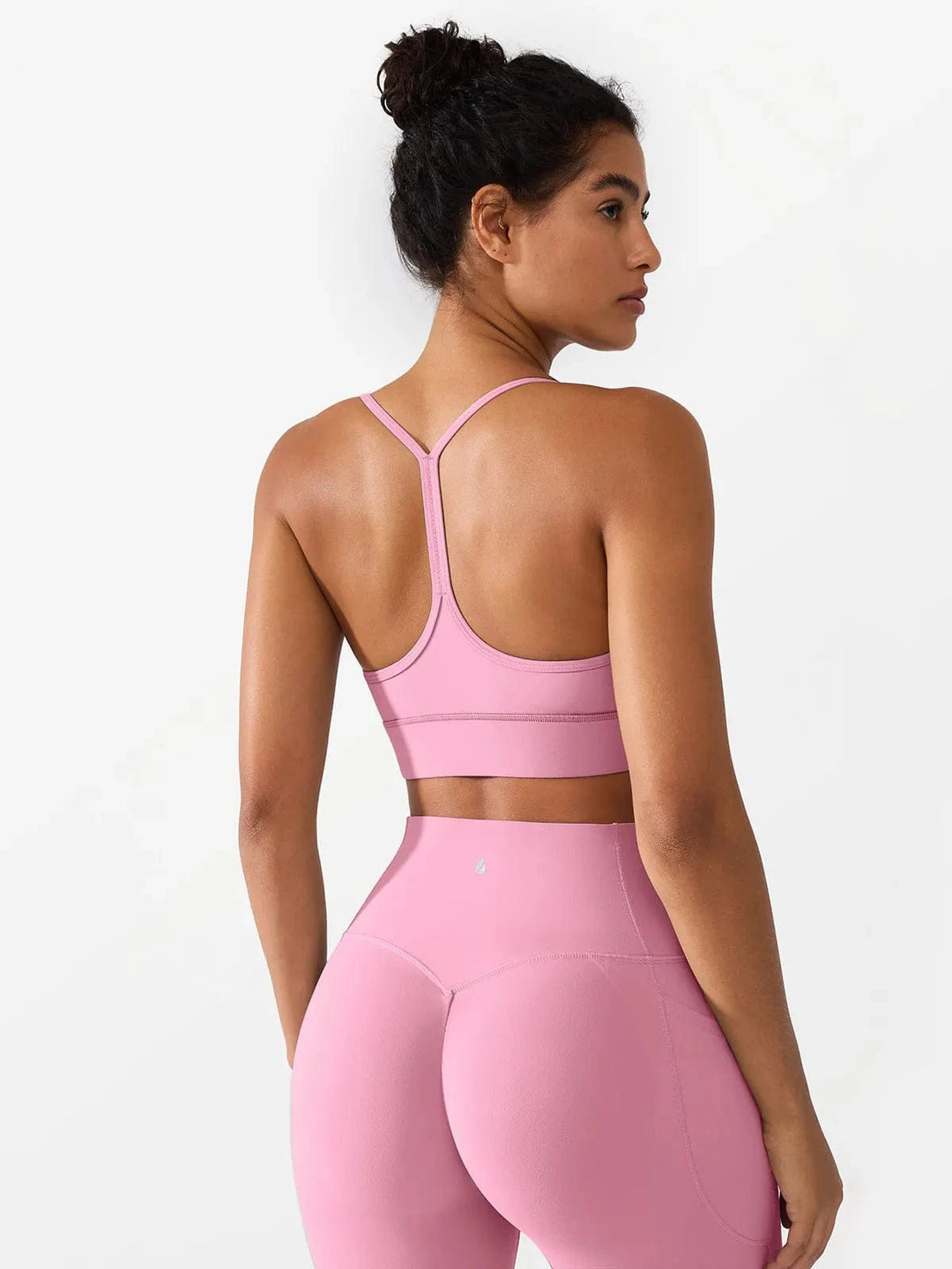 A model wearing a BRXL® Flow Y Racerback Bra with Low Cut and Spaghetti Straps in