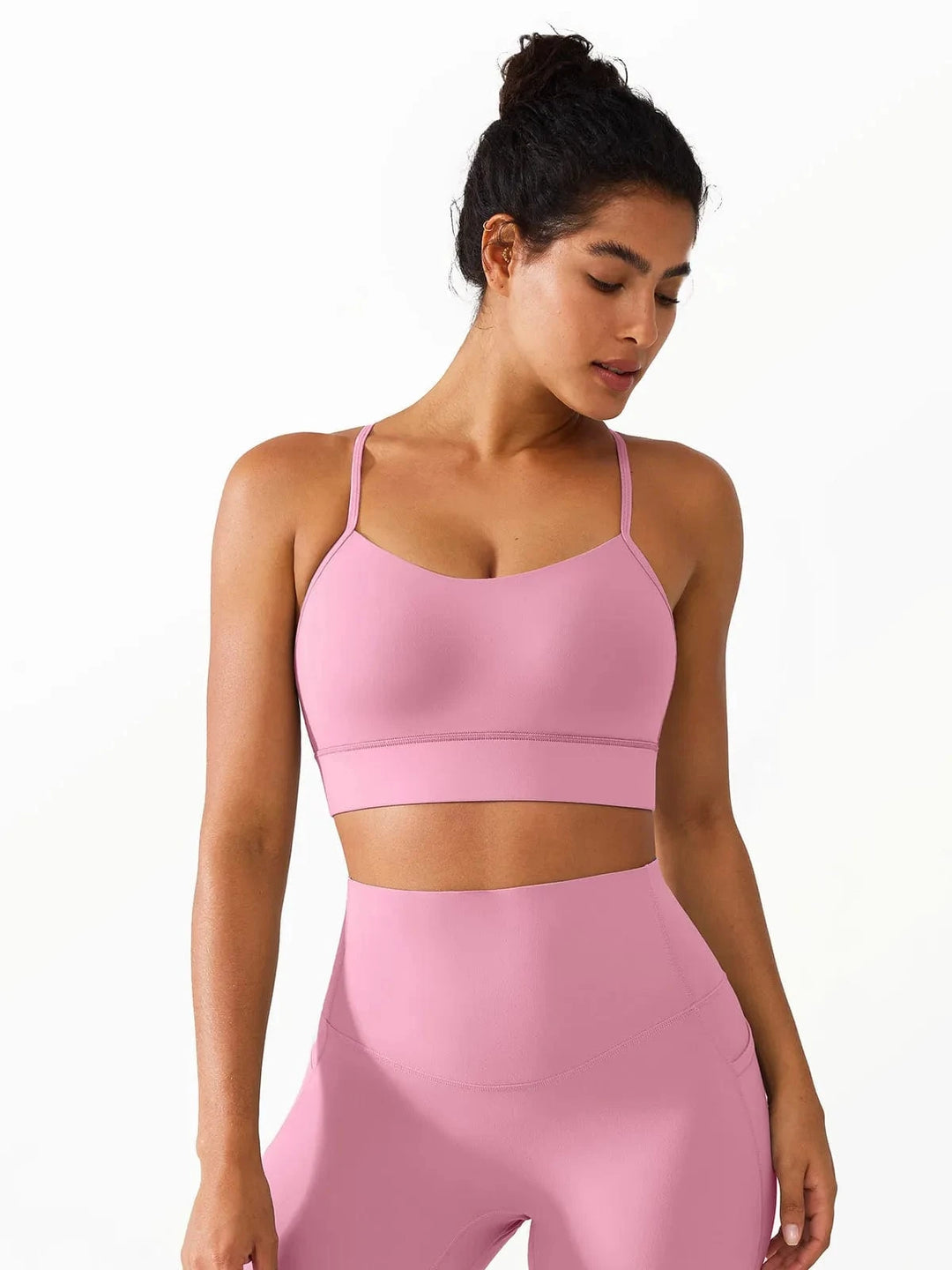 A model wearing a BRXL® Flow Y Racerback Bra with Low Cut and Spaghetti Straps in