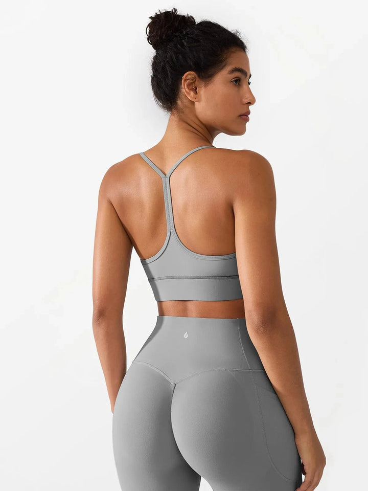 A model wearing a BRXL® Flow Y Racerback Bra with Low Cut and Spaghetti Straps in