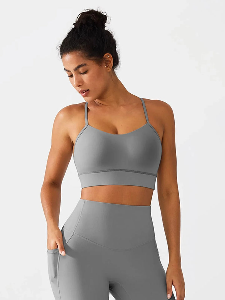 A model wearing a BRXL® Flow Y Racerback Bra with Low Cut and Spaghetti Straps in