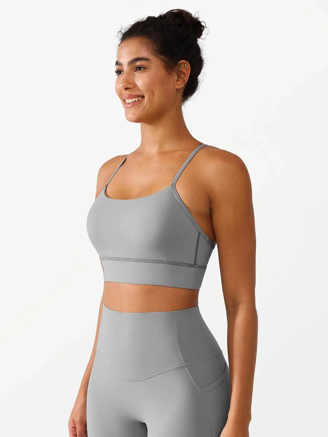 A model wearing a BRXL® Flow Y Racerback Bra with Low Cut and Spaghetti Straps in