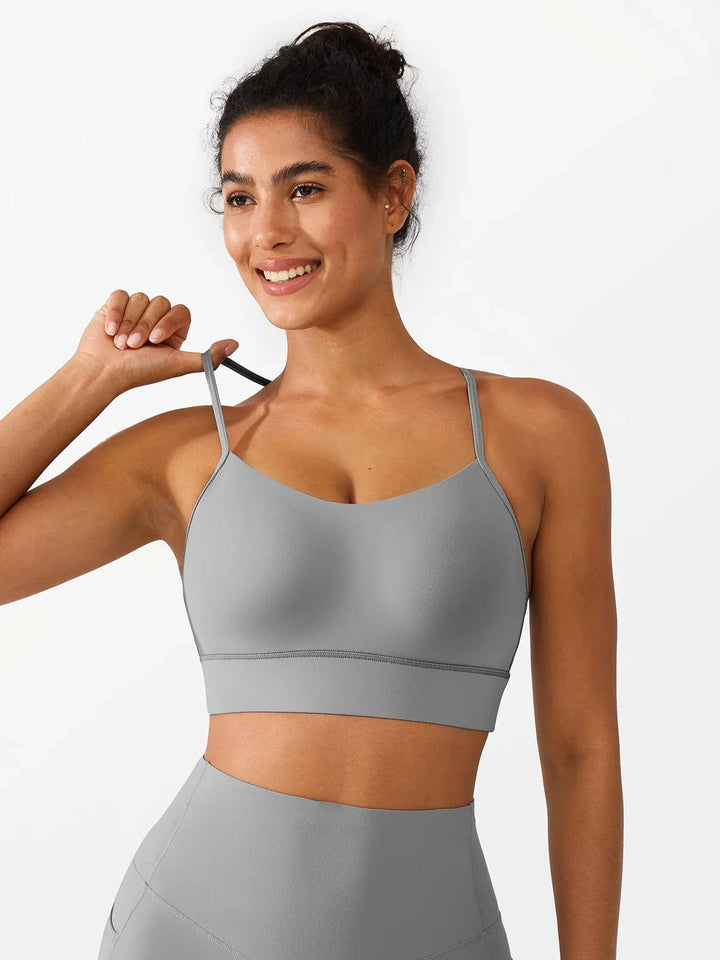 A model wearing a BRXL® Flow Y Racerback Bra with Low Cut and Spaghetti Straps in