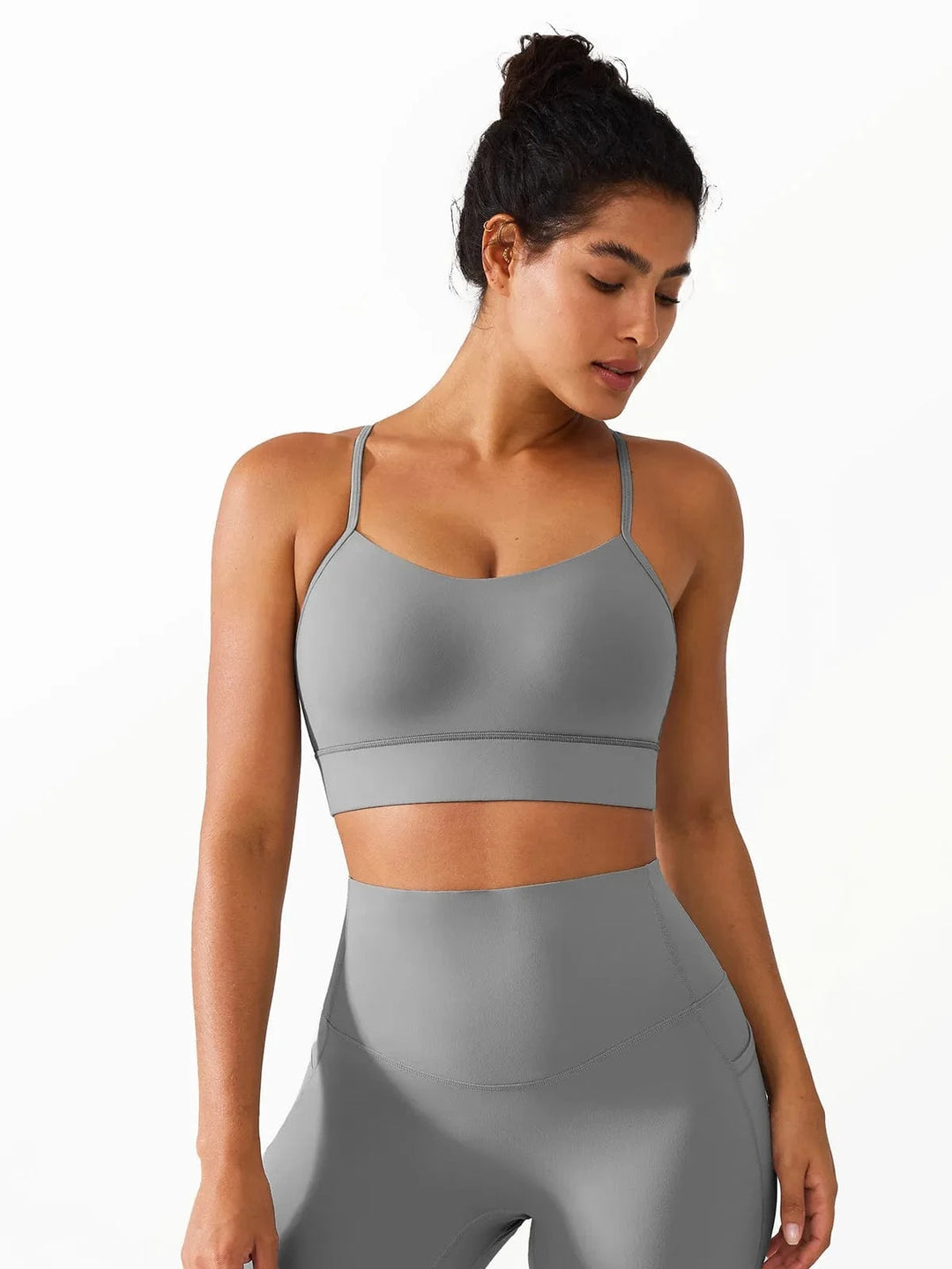 A model wearing a BRXL® Flow Y Racerback Bra with Low Cut and Spaghetti Straps in